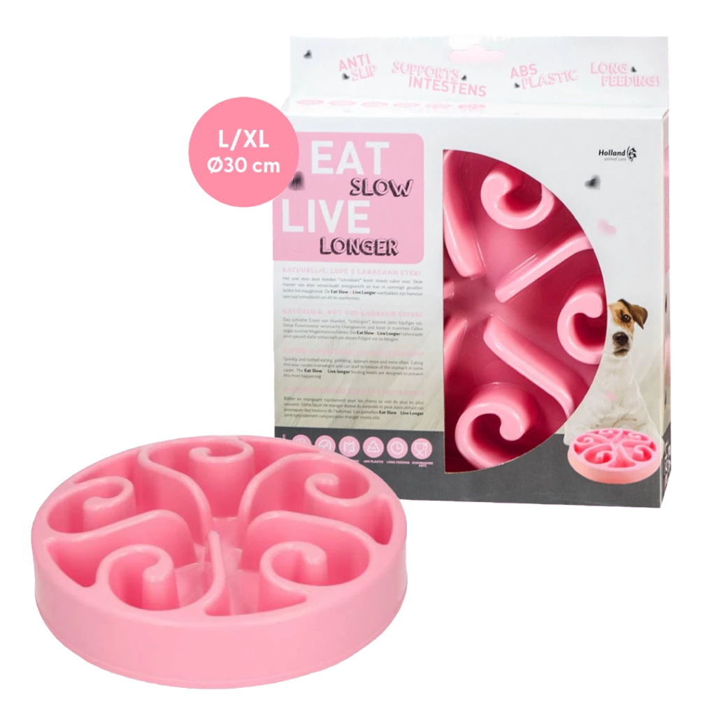 Rosa Napf ‚Eat Slow Live Longer‘ mit Spiralstruktur zur Verlangsamung der Futteraufnahme, in Verpackung mit Hundebild und Hinweisen zu Funktion und Material.