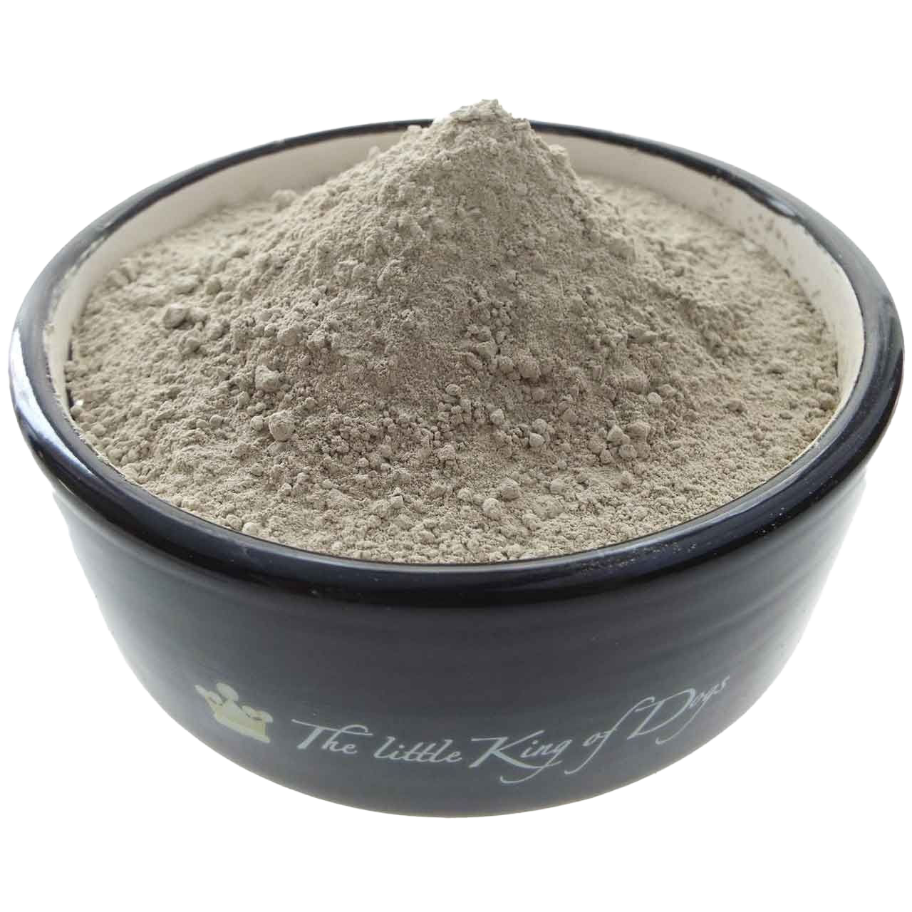 Eine dunkelgraue Schüssel mit der Aufschrift „The little King of Dogs“, gefüllt mit hellgrauem, feinpudrigem Pulver, das kuppelförmig aufgeschüttet ist.