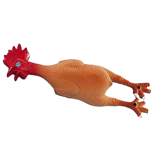 Gummihuhn mit rotem Kopf, blauen Augen und orangefarbenem Körper, liegt auf dem Rücken mit ausgestreckten Beinen.