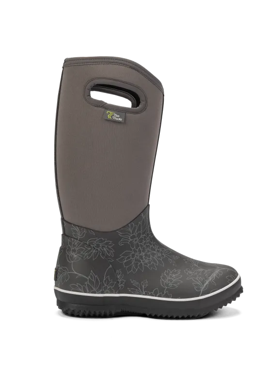 Grauer Gummistiefel mit floralem Muster, Grifföffnung am Schaft und schwarzer, stark profilierter Sohle.