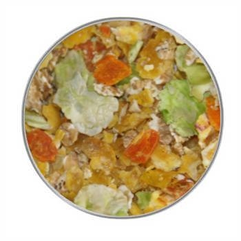 Eine bunte Flockenmischung mit orangenen, grünen und gelben Gemüsechips sowie kleinen Haferflocken, in einer kreisförmigen Draufsicht gleichmäßig verteilt.