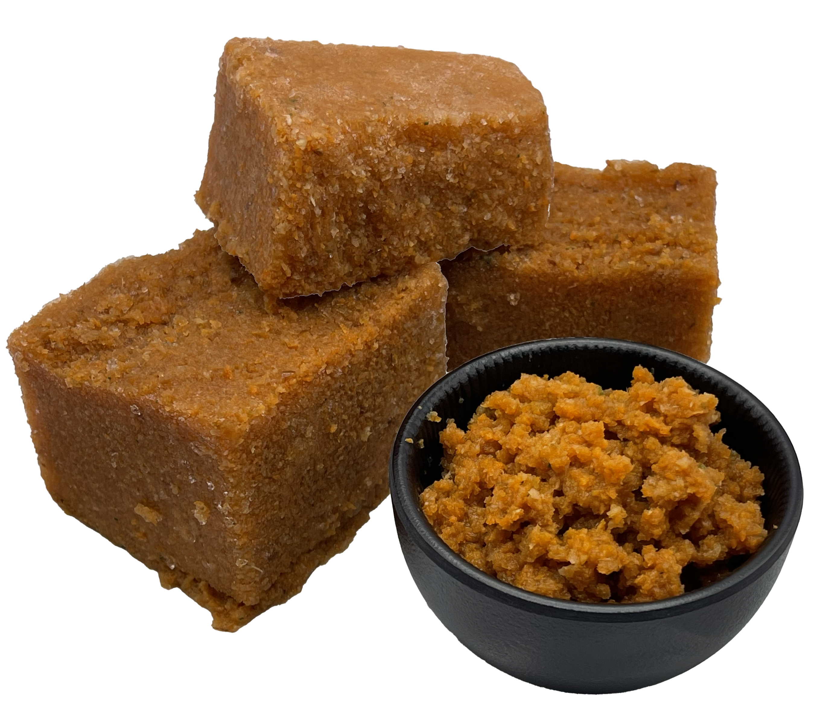 Gartenfreude 1000g Drei gefrorene, hellbraun-orange Würfel aus püriertem Gemüse. Daneben steht eine schwarze Schale mit aufgetauter, grobkörniger Gemüsemasse in warmem Orangeton.