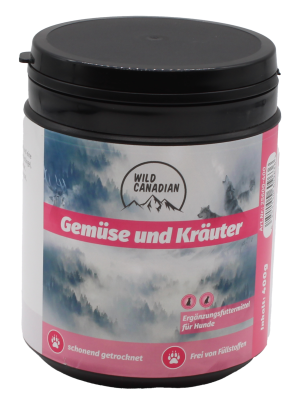 Eine runde schwarze Kunststoffdose mit Schraubdeckel und Etikett in Rosa und Blau mit der Aufschrift „Gemüse und Kräuter“. Das Etikett zeigt eine neblige Berglandschaft mit dem Logo „Wild Canadian“.