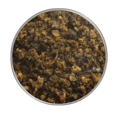 Ein kreisförmig ausgeschnittener Blick auf eine grobe, faserige Mischung in Braun- und Beigetönen mit unregelmäßiger Struktur. Der Hintergrund ist vollständig ausgeblendet.