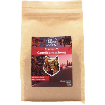 Ein brauner Standbeutel mit rotem Etikett und der Aufschrift „Premium Gemüsemischung“. In der Mitte ein Sichtfenster in Tierform mit bunter Trockenmischung aus Gemüseflocken.