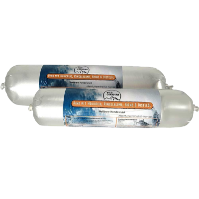 Zwei haltbare Hundewürste in glänzend silberner Kunststoffhülle. Auf dem Etikett steht „Rind mit Hokkaido, Ringelblume, Birne & Distelöl“. Die Verpackung zeigt ein Bergpanorama mit Waldmotiv.