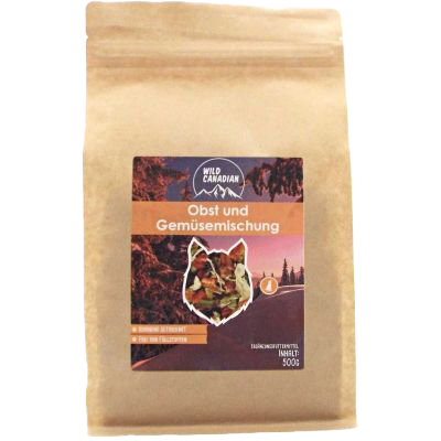 Eine braune Papierverpackung mit aufrechtem Stand, vorne ein dunkles Etikett mit Naturmotiv und Hundesilhouette, Sichtfenster mit getrockneter Obst- und Gemüsemischung.